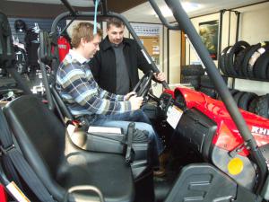 Jason Lannon, left, owner of M&F Motors in Stephenville, Nfld., shows potential buyer Bill Oliver the features on the Yamaha Rhino.