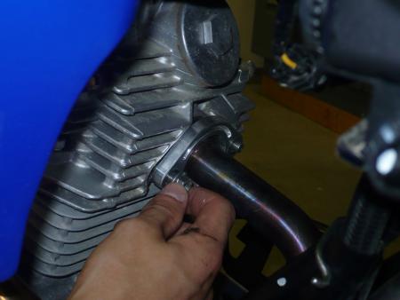 Put a dab of blue Loctite on the threads of the header nuts and finger tighten. Only tighten them finger-tight so you can move the muffler around and line up the bolts on the muffler easier.